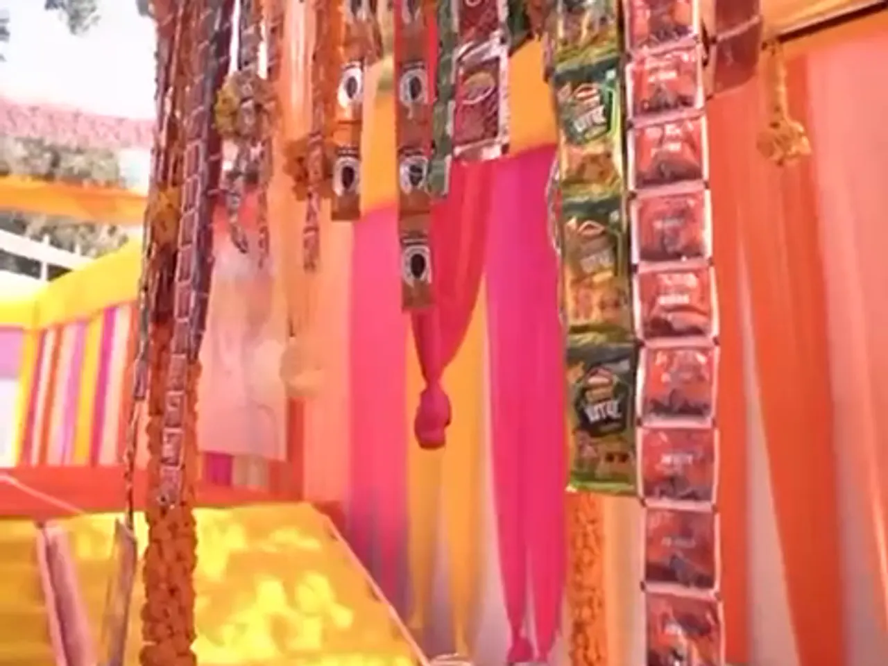 The candy bar stall dressed with hanging candy strips and striped drapes