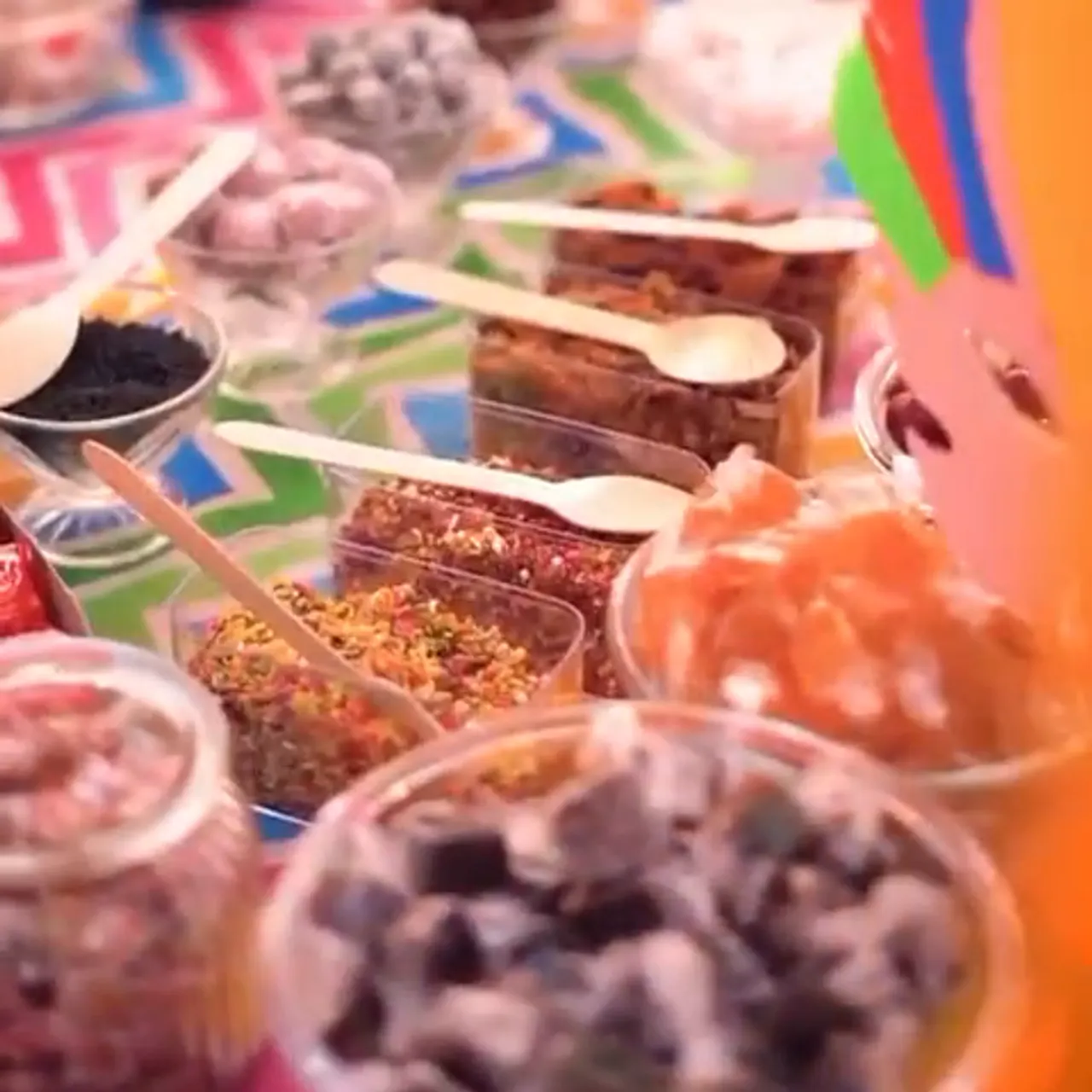 Bowls of retro sweets with wooden scoops along the candy bar counter
