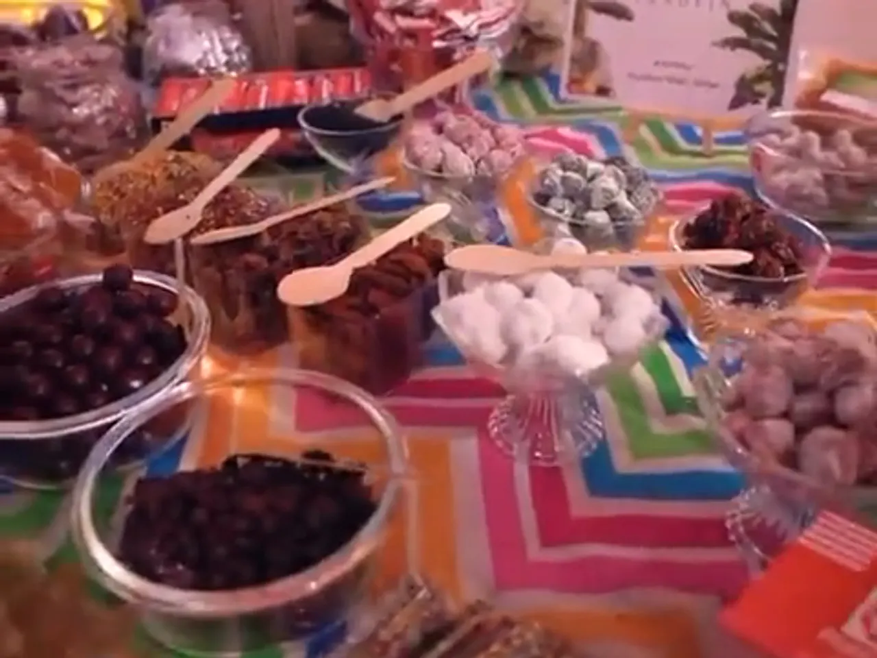 Bowls of sweets and wooden scoops along the candy bar counter