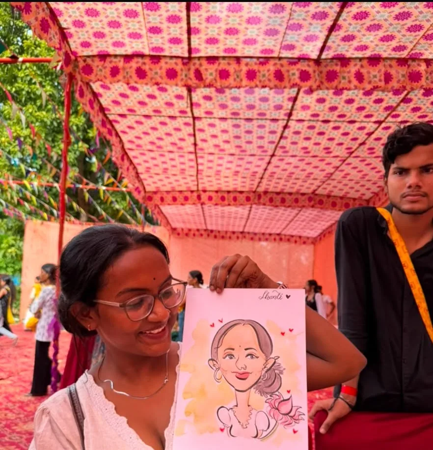 A guest holding the caricature just drawn of her, her name written across the bottom of the sheet